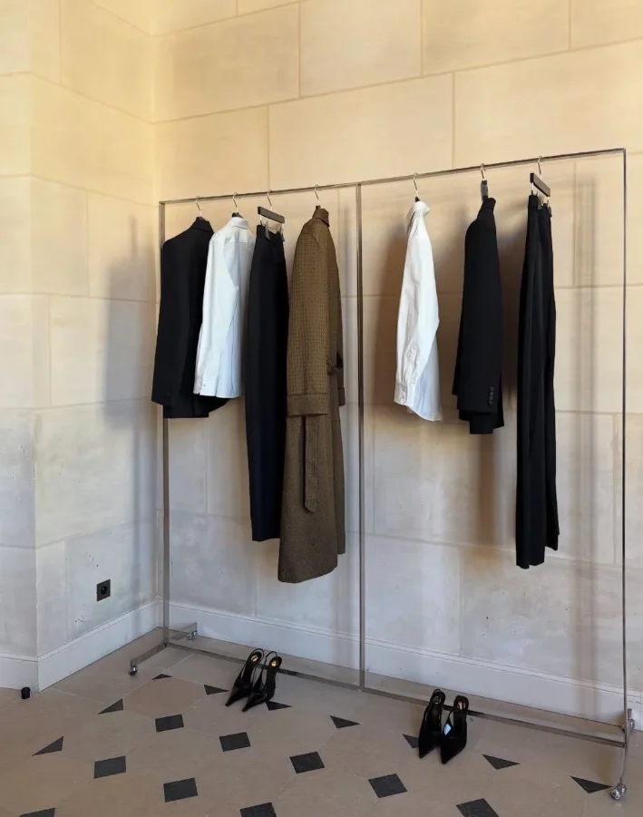 Curated wardrobe pieces hanging on a clothing rack